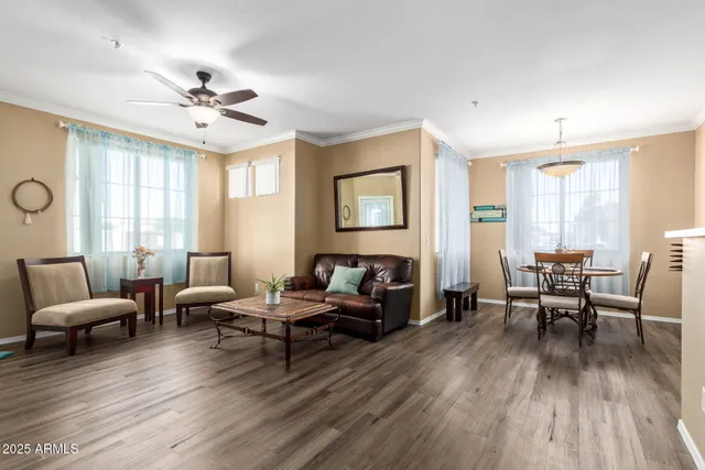 a living room with furniture and wooden floor