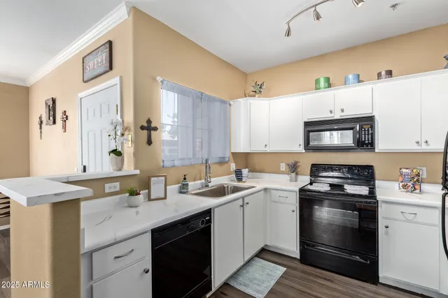 a kitchen with a sink stove and microwave