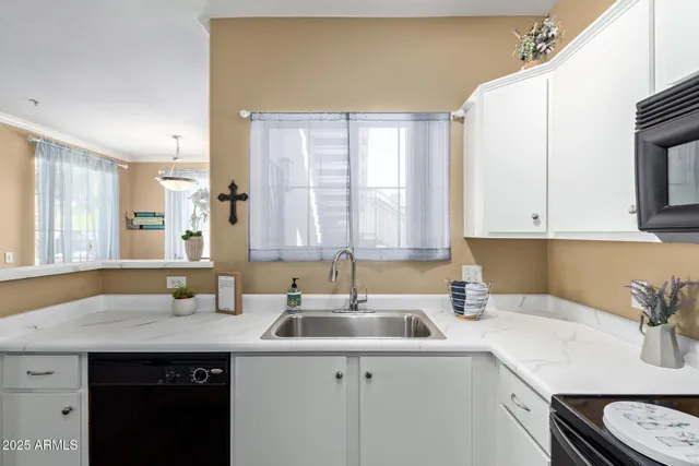 a kitchen with a sink cabinets and window