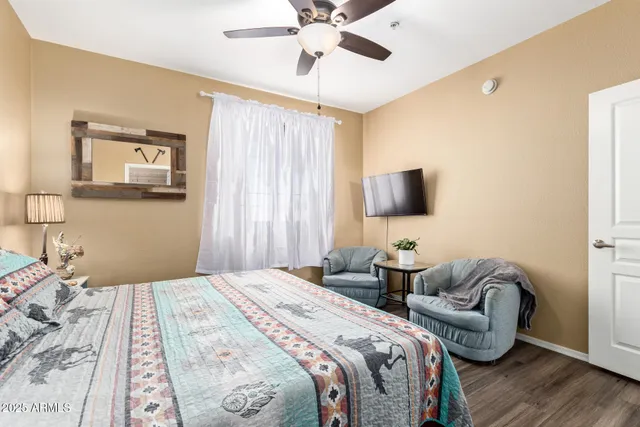 a bedroom with two beds and a chandelier