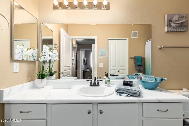 a bathroom with double sink and a mirror