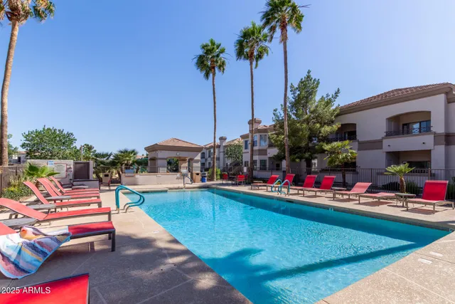 a view of a swimming pool with a lounge chairs