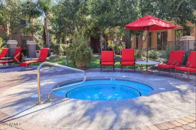 an outdoor space with swimming pool and furniture