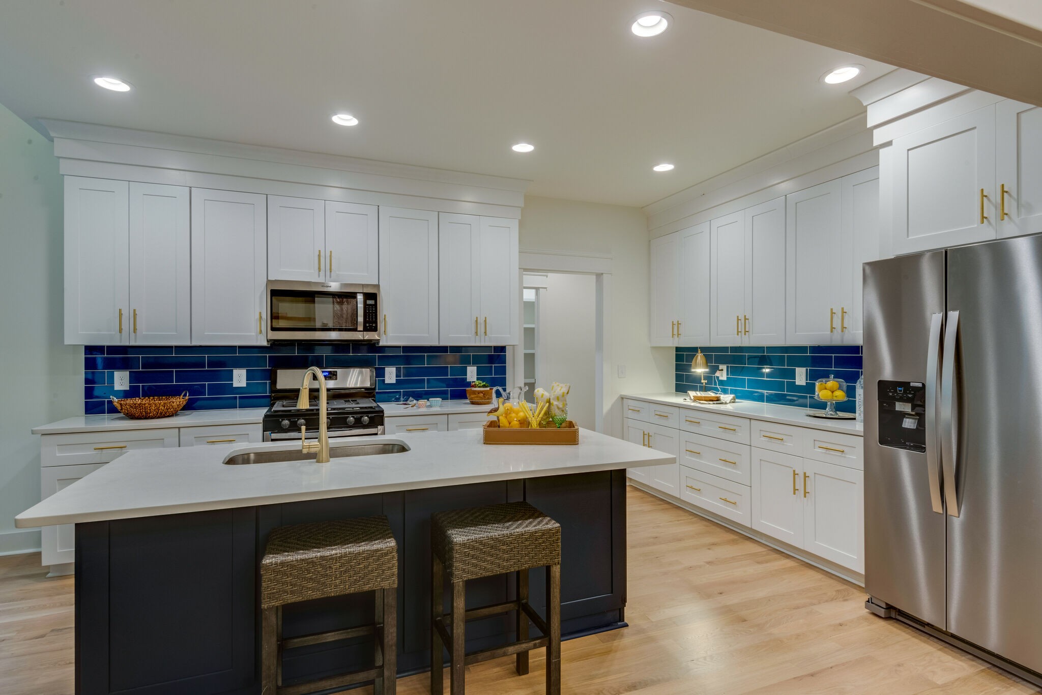 1106 Garton Road Burns, TN 37029 - Photo 14 of 46 a kitchen with white cabinets stainless steel appliances and a center island
