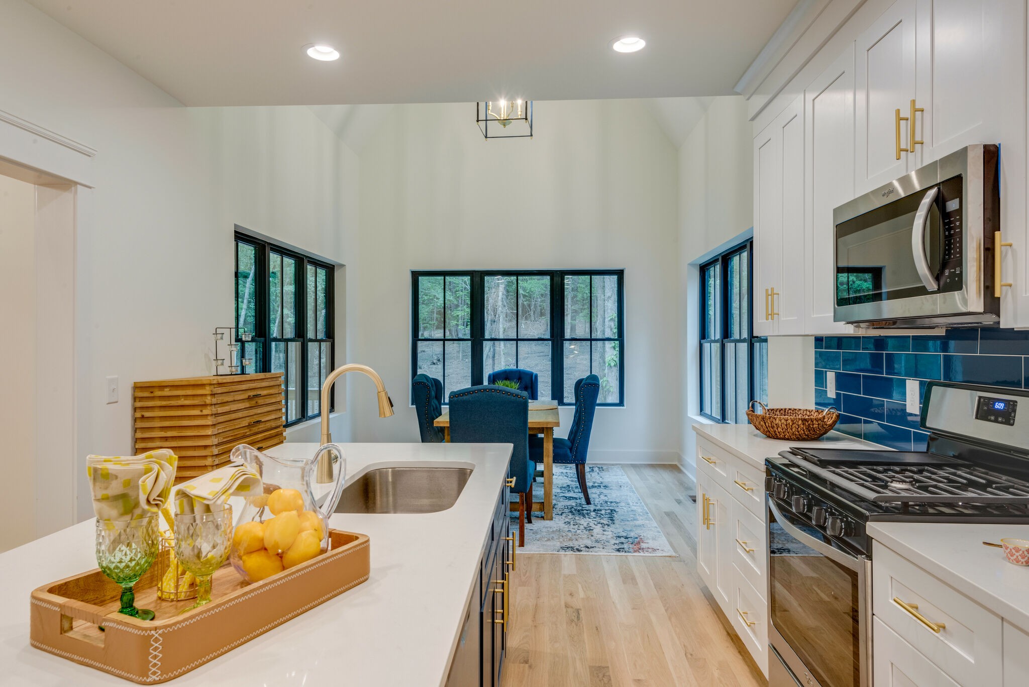 1106 Garton Road Burns, TN 37029 - Photo 16 of 46 a kitchen with stainless steel appliances granite countertop a stove a sink dishwasher and a microwave with wooden floor