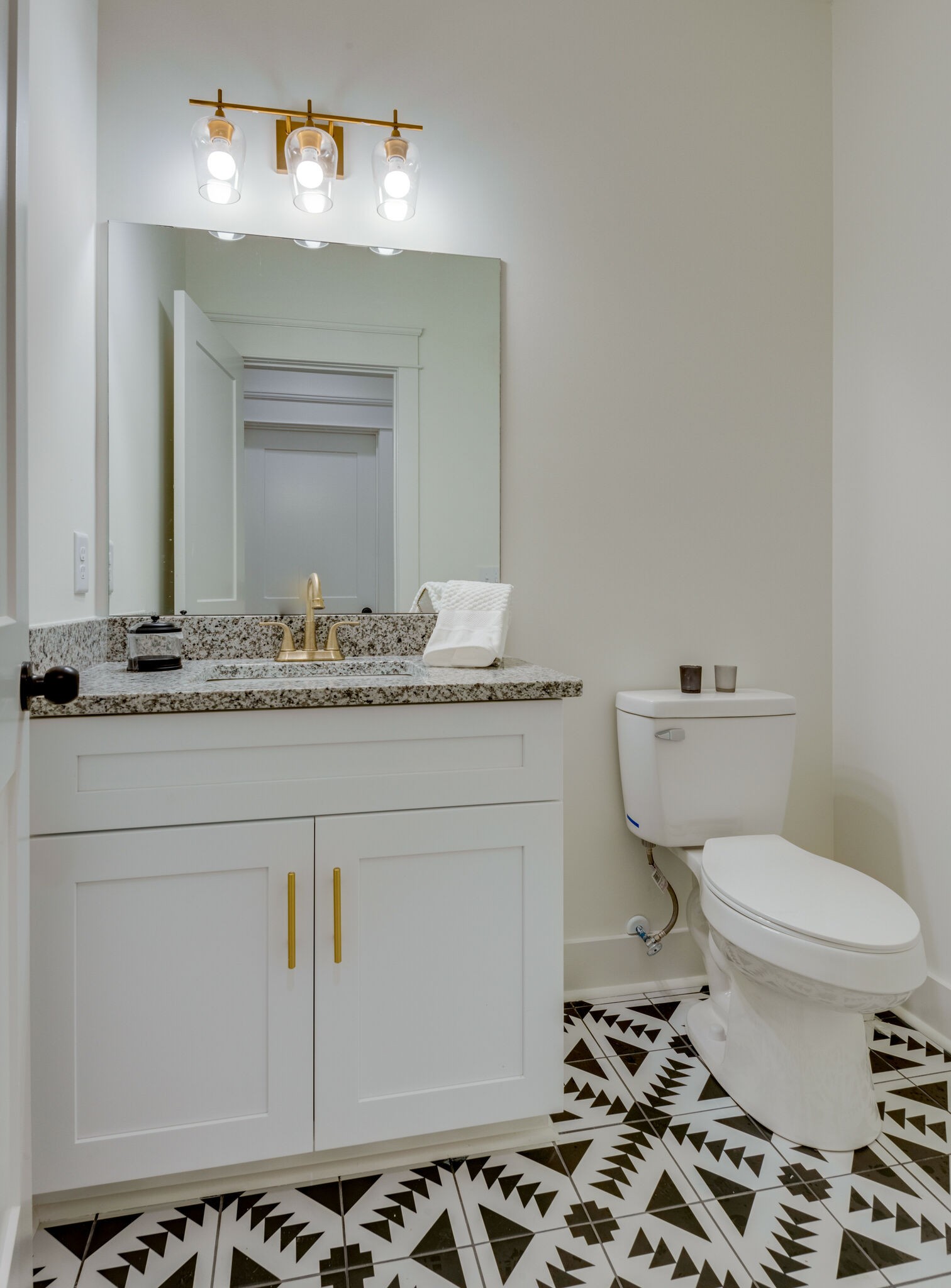 1106 Garton Road Burns, TN 37029 - Photo 32 of 46 a bathroom with a toilet a sink and a mirror