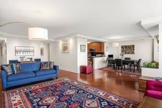 a living room with furniture wooden floor and a table