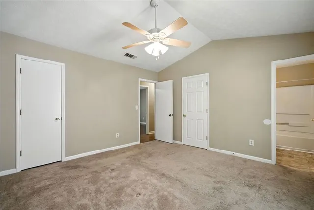 a view of an empty room with a ceiling fan