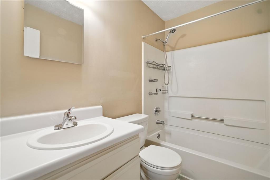 3045 Wildflower Lane Southwest Snellville, GA 30039 - Photo 22 of 35 a bathroom with a sink a toilet and shower