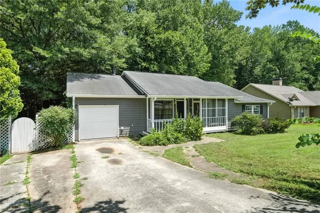 a front view of a house with a yard and outdoor seating