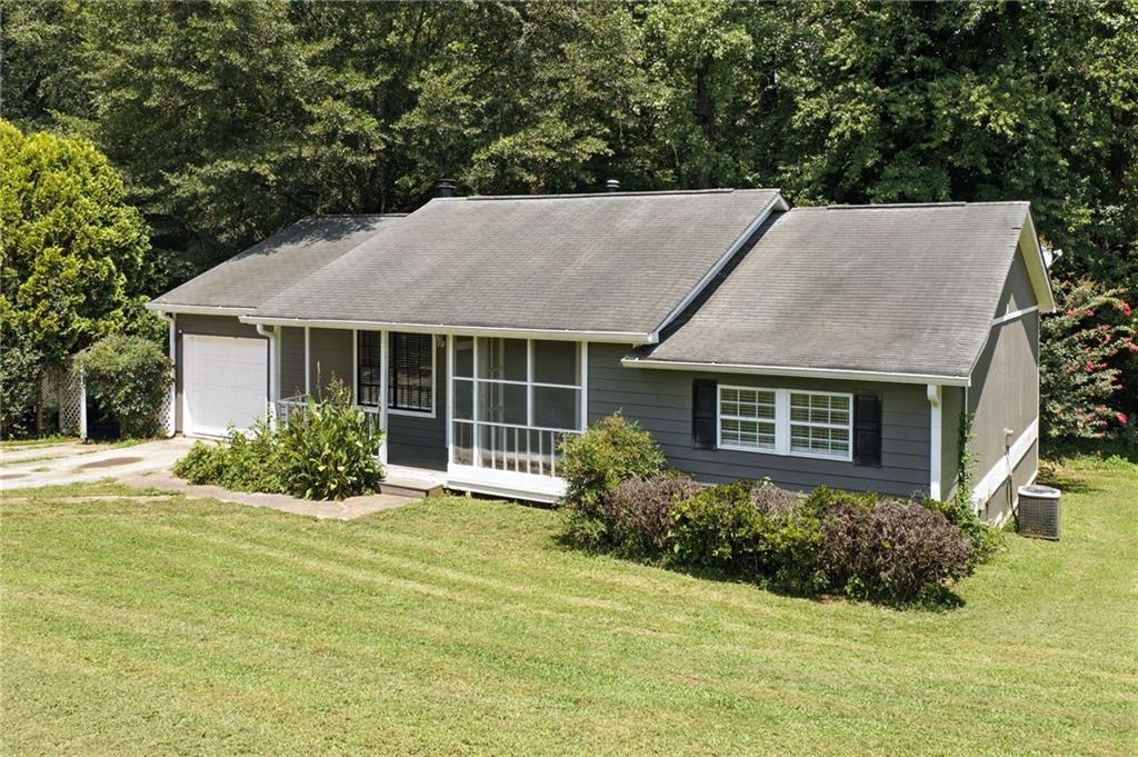 3045 Wildflower Lane Southwest Snellville, GA 30039 - Photo 25 of 35 a front view of a house with a yard and outdoor seating