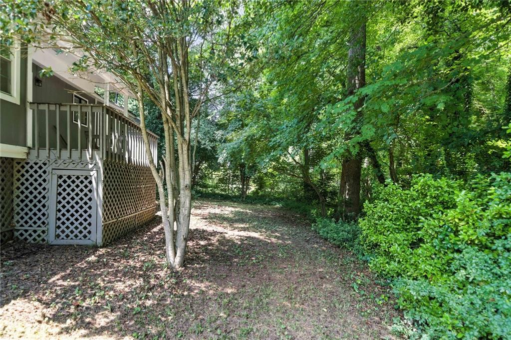 3045 Wildflower Lane Southwest Snellville, GA 30039 - Photo 29 of 35 a view of a house with a tree in the yard