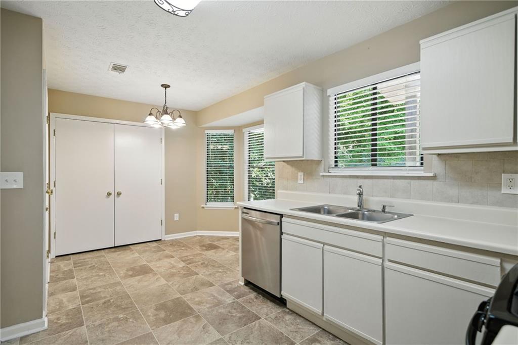 3045 Wildflower Lane Southwest Snellville, GA 30039 - Photo 3 of 35 a view of a kitchen with a sink and chandelier