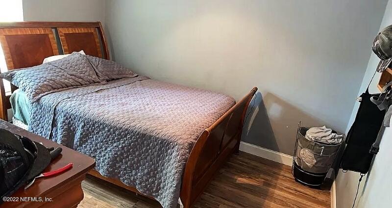 54148 Sherwood Road Callahan, FL 32011 - Photo 12 of 17 a bedroom with a bed and wooden floor