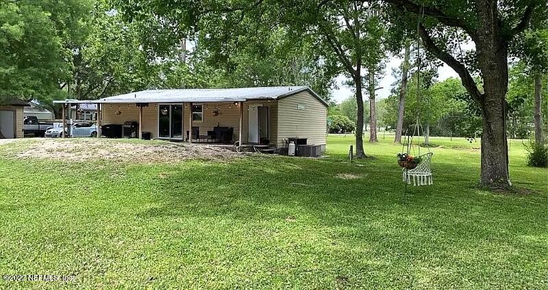 54148 Sherwood Road Callahan, FL 32011 - Photo 15 of 17 a view of a house with backyard and a tree