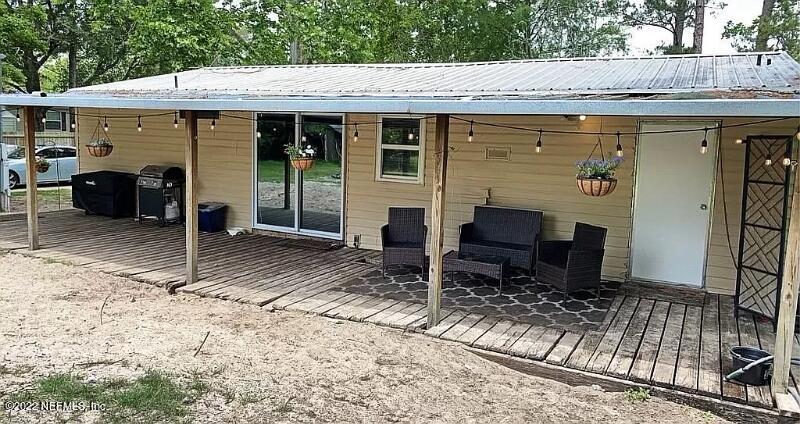 54148 Sherwood Road Callahan, FL 32011 - Photo 2 of 17 a backyard of a house with yard fire pit barbeque oven and outdoor seating