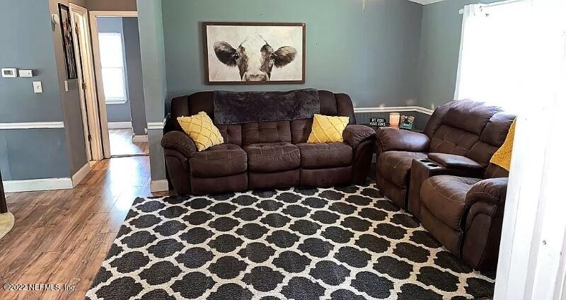 54148 Sherwood Road Callahan, FL 32011 - Photo 5 of 17 a living room with furniture and a black gate