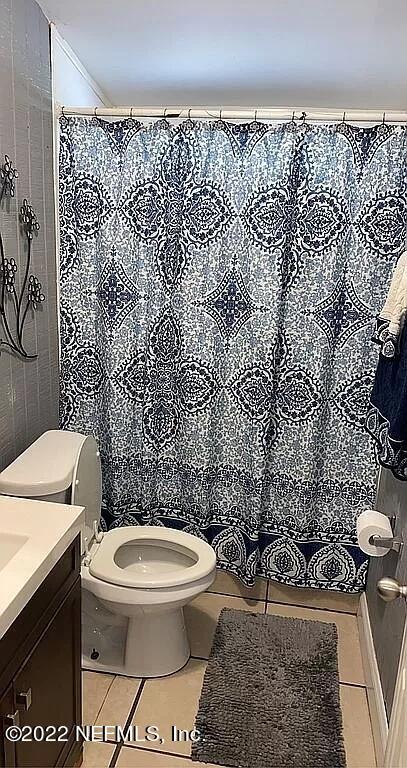 54148 Sherwood Road Callahan, FL 32011 - Photo 9 of 17 a white toilet sitting next to a shower curtain