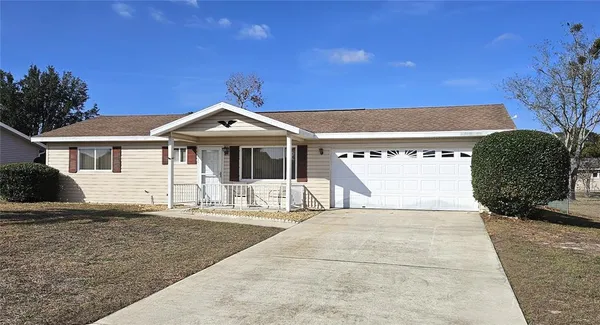 a front view of a house with a garden and yard