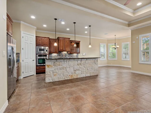 a kitchen with stainless steel appliances a sink stove and refrigerator