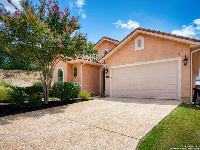 a view of a white house with a yard