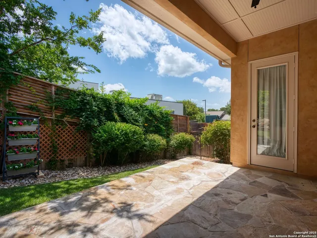 a backyard of a house with table and chairs