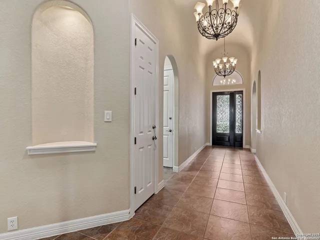 a living room with furniture kitchen and a wooden floor