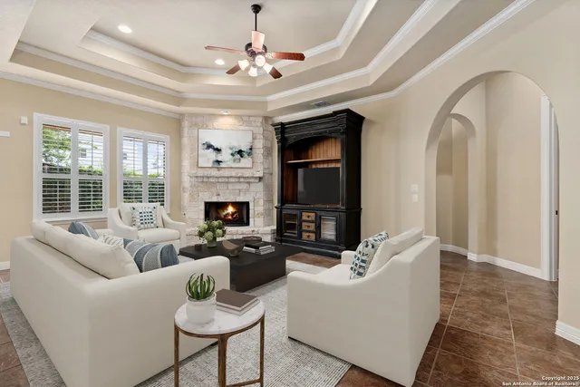 a living room with furniture and a fireplace with wooden floor