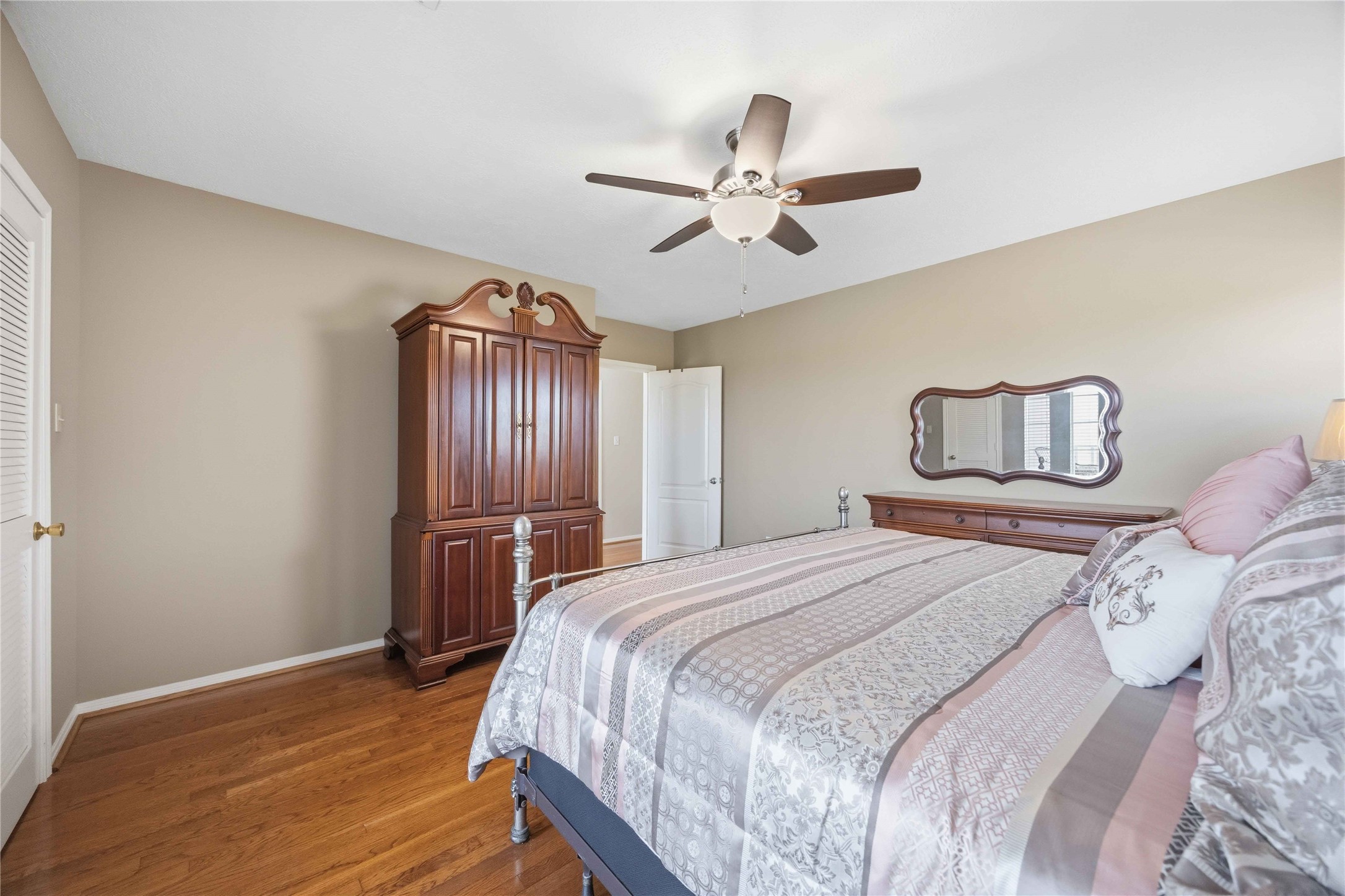 12075 Farm To Market 359 Hempstead, TX 77445 - Photo 35 of 46 a bedroom with a bed and a chandelier