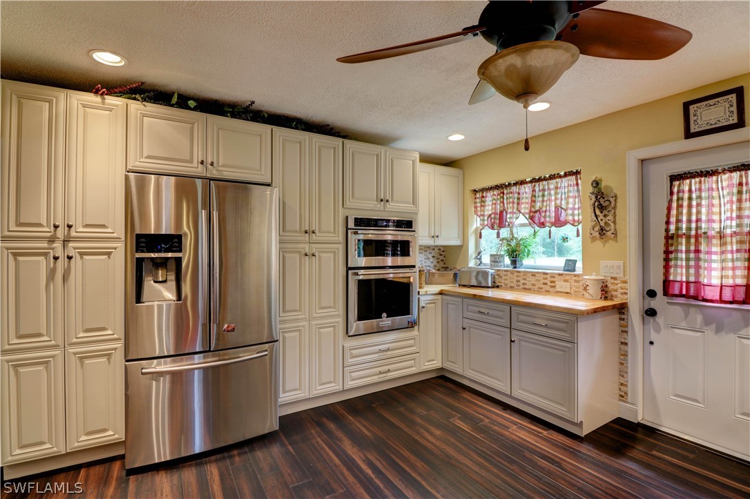 10550 Deal Road North Fort Myers, FL 33917 - Photo 17 of 35 a kitchen with stainless steel appliances and white cabinets
