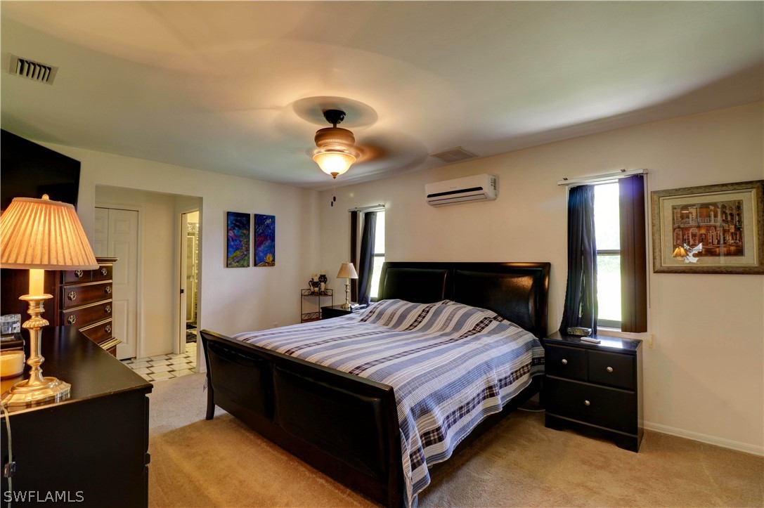 10550 Deal Road North Fort Myers, FL 33917 - Photo 24 of 35 a bed room with a bed and a lamp