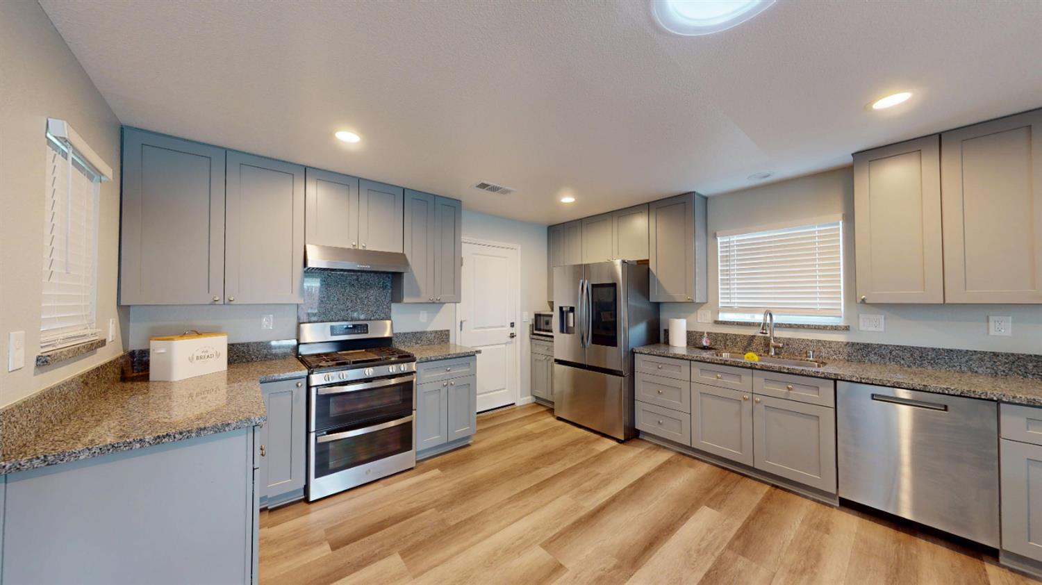 3912 Carver Road Modesto, CA 95356 - Photo 3 of 16 Completely remodeled and equipped with soft closing cabinetry, upgraded stainless appliances including self-cleaning dual ovens with convection feature and gas range with grill, stainless overhead vent and matching dishwasher, stainless sing and faucet and recessed lighting. Quartz countertops with plenty of space for meal prepping or setting up a buffet. Pantry closet with frosted glass door.