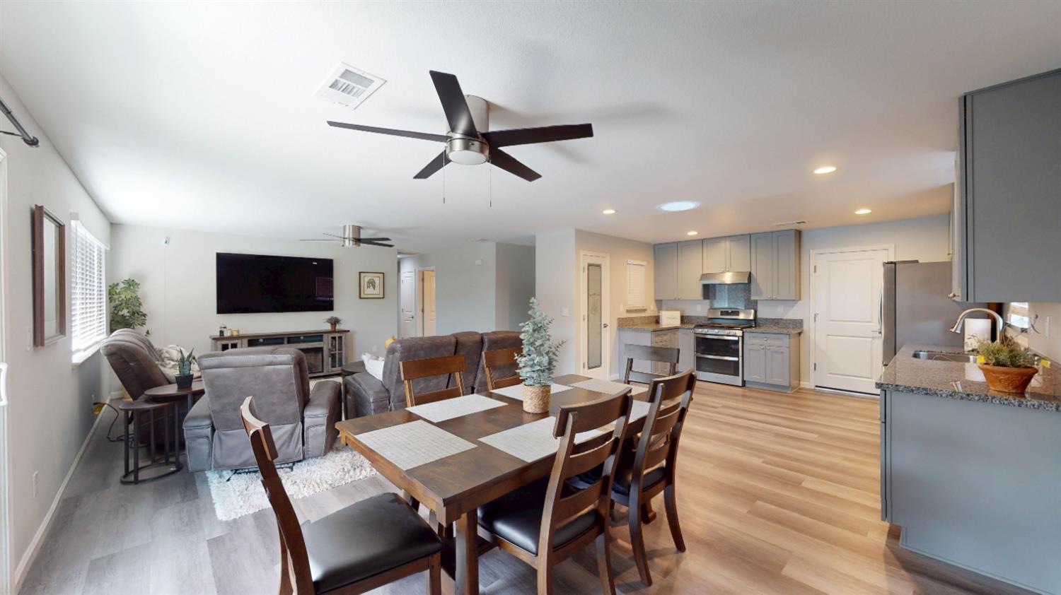 3912 Carver Road Modesto, CA 95356 - Photo 4 of 16 Looking from the far corner of the dining room you can get a feel for the open space. Where there once was a wall separating the family room you now have a room where everyone can feel included and the cook doesn't miss anything. The tall cabinet door in the kitchen is the pantry. The door leads into the two car garage.