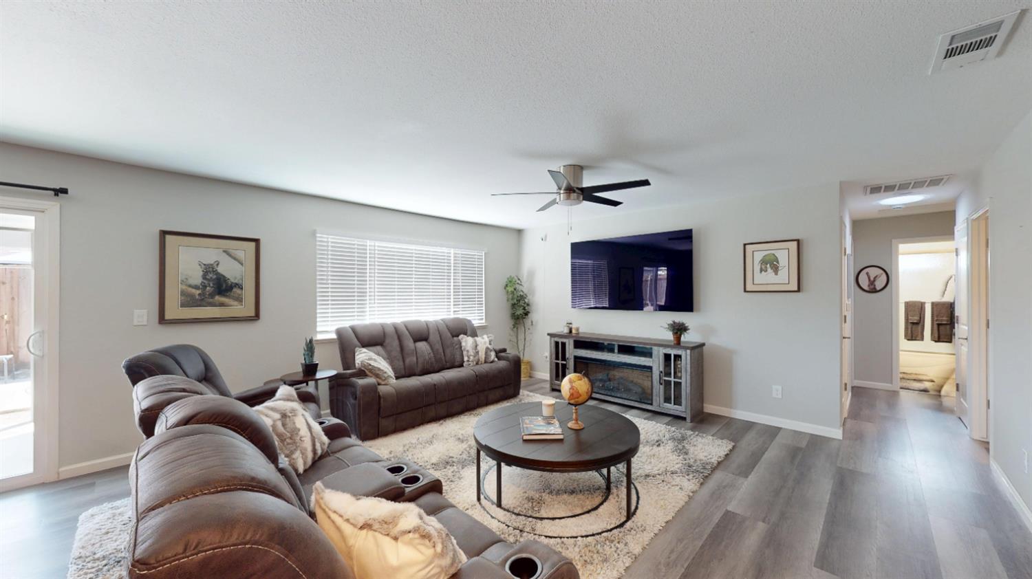 3912 Carver Road Modesto, CA 95356 - Photo 6 of 16 Another view of the family room looking towards the hallway and bathroom. Sliding glass door opens to the backyard and patio/pool area.