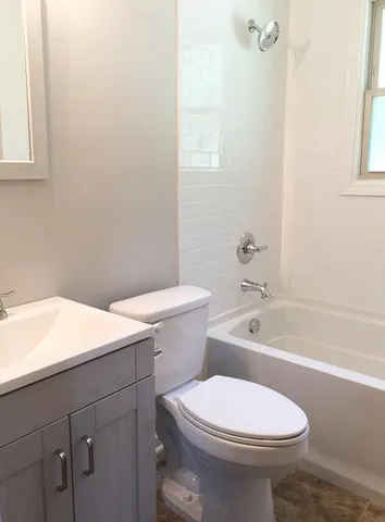 a bathroom with a sink a toilet and bathtub
