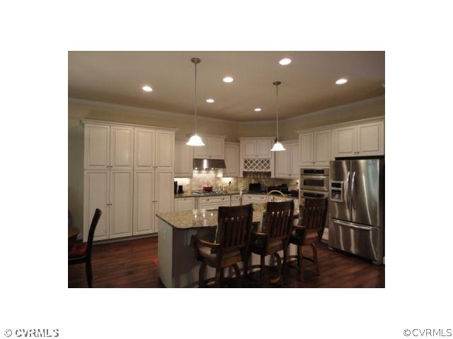 17911 Beach Road Chesterfield, VA 23838 - Photo 3 of 12 a living room with stainless steel appliances kitchen island granite countertop a refrigerator a sink a dining table and chairs