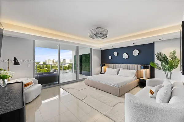 a large bedroom with a bed and a couch