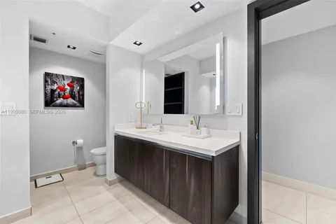 a view of a bathroom sink mirror and toilet