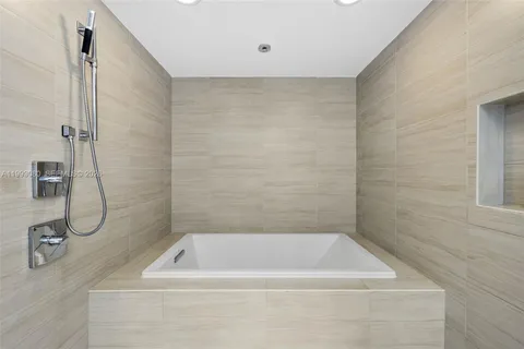 a bedroom with a large bed and a night stand