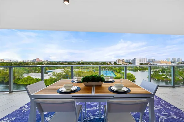 a dining room with furniture and a floor to ceiling window