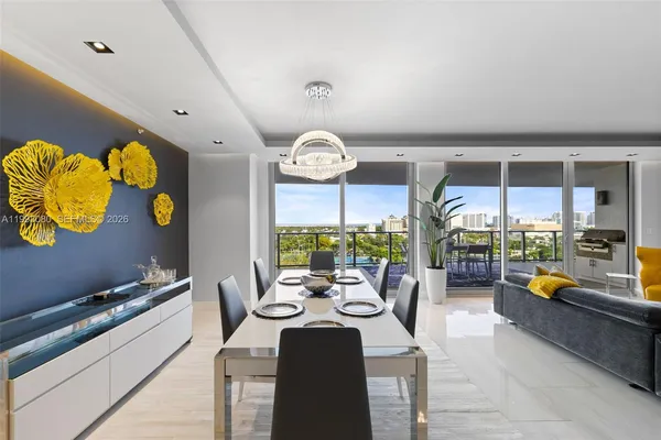 a view of kitchen with stainless steel appliances kitchen island granite countertop a sink and a counter top space
