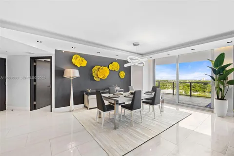 a living room with fireplace furniture and a large window