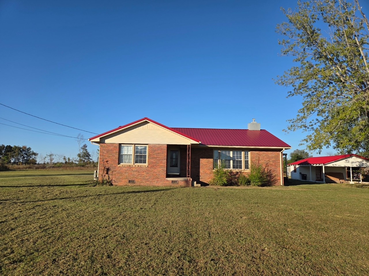 126 Dunn Road Leoma, TN 38468 - Photo 1 of 16 a front view of a house with a yard and trees