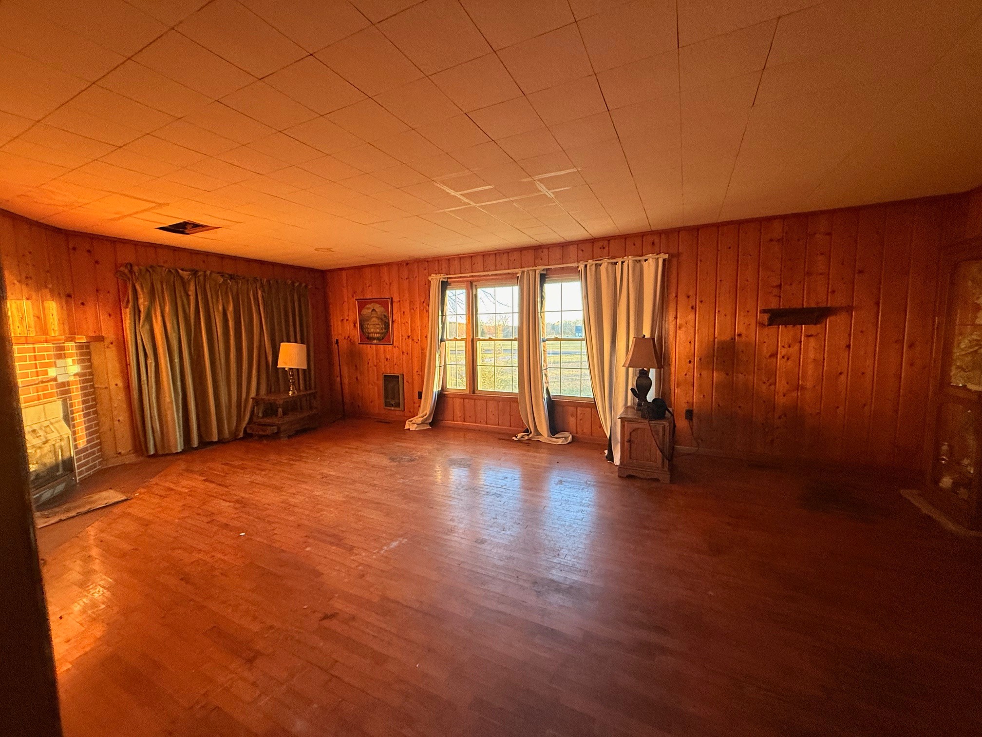 126 Dunn Road Leoma, TN 38468 - Photo 9 of 16 an empty room with wooden floor and windows