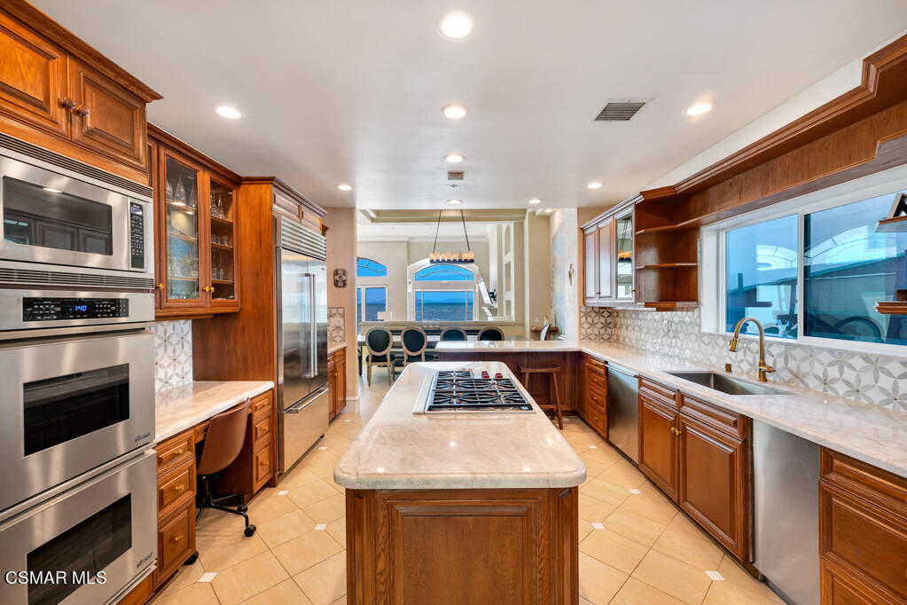 1245 Capri Way Oxnard, CA 93035 - Photo 18 of 94 a kitchen with stainless steel appliances granite countertop a sink and stove