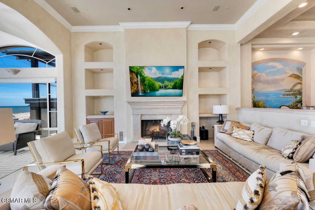 1245 Capri Way Oxnard, CA 93035 - Photo 30 of 94 a living room with furniture a fireplace and a flat screen tv