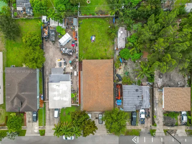 an aerial view of a house with a yard basket ball court and outdoor seating