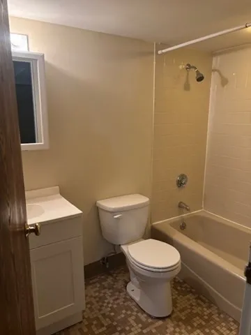 a bathroom with a toilet a sink and shower