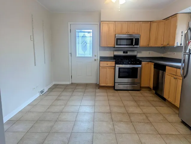 a kitchen with a stove a microwave and a sink