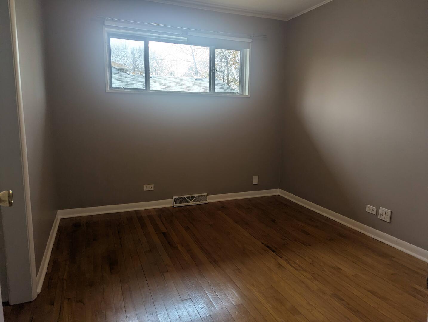 413 West Palatine Road Palatine, IL 60067 - Photo 15 of 19 a view of an empty room with wooden floor and a window